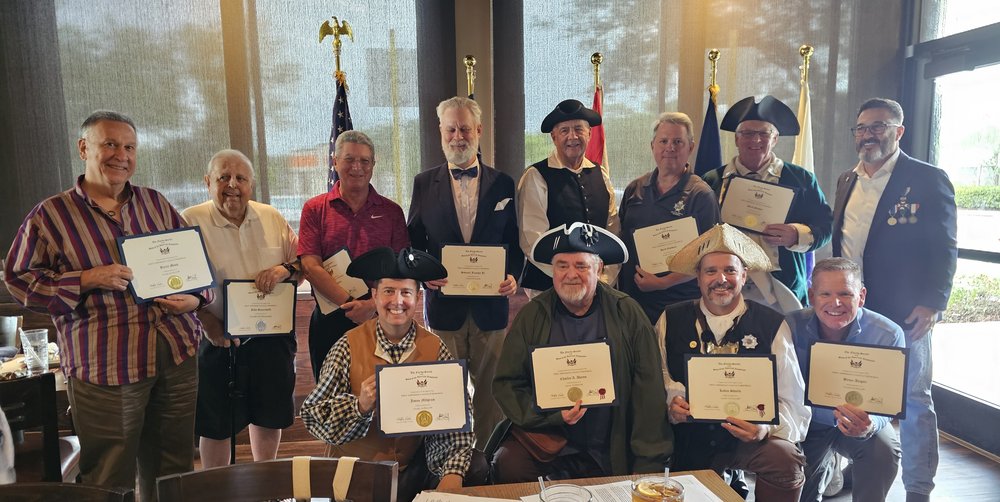 FAAM Chair presenting FAAM Fellow and Minuteman certificates to Fort Lauderdale Compatriots. Back row (left to right): Barry Moss, John Sauerwald, Pete Stevenson, Samuel Frankel Jr., Tom Carpenter, Herb Gardner, Mark Snider, FAAM Chair. Front row (left to right): Jason Milgram, Chuck Adams, Kevin Shurte, Bruce Angier