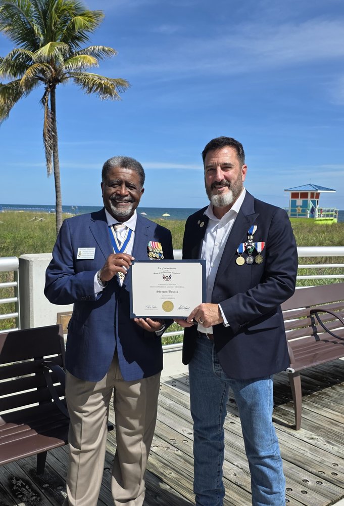Sherwin Bostick, President of the Port St.Lucie Chapter receiving his FAAM 250 Fellow certificate & coin from the FAAM Chair at the future site of the Memorial