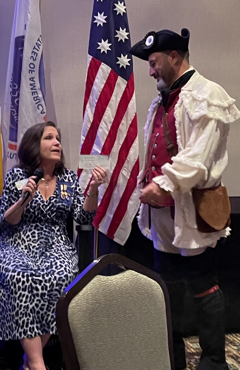 President of the FLSSAR Ladies Auxiliary Becky Washler (left) presenting $5,000 donation check to FAAM Chair (right)
