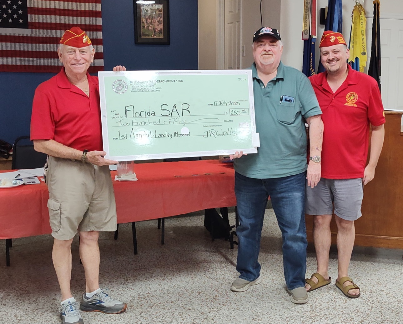 Jim Wells (left), Marine Corps League (MCL), presenting donation from MCL Intracoastal Det 1058 to Chuck Adams(middle) and Phil Burns(right)