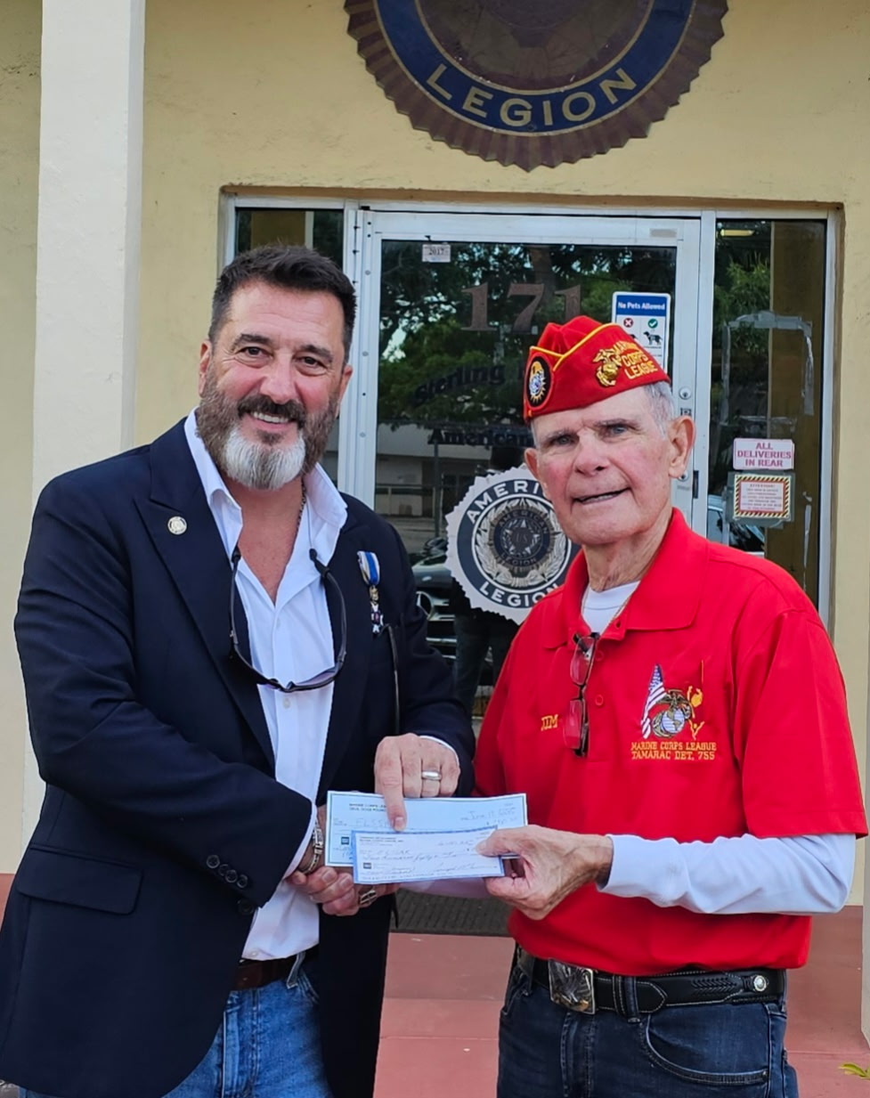 James Clark (right), MCL, presenting donation from the Tamarac Detachment & Devil Dog's Pound 192 to the FAAM Chair (left)