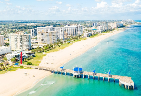 Aerial side view of Pompano Beach Pier with red arrow showing proposed memorial location