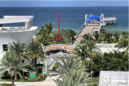 Front view of Pompano Beach Pier area with red arrow showing proposed memorial location